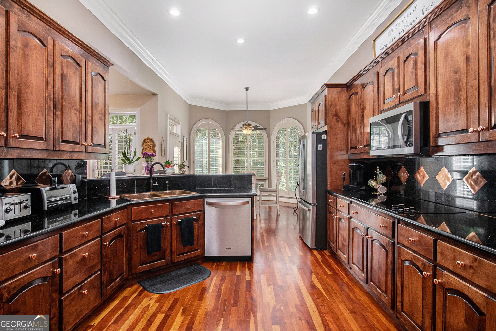 131 Winesap Way Clarkesville, GA 30523 - Photo 15 of 65 a kitchen with stainless steel appliances granite countertop a stove a sink dishwasher and cabinets with wooden floor