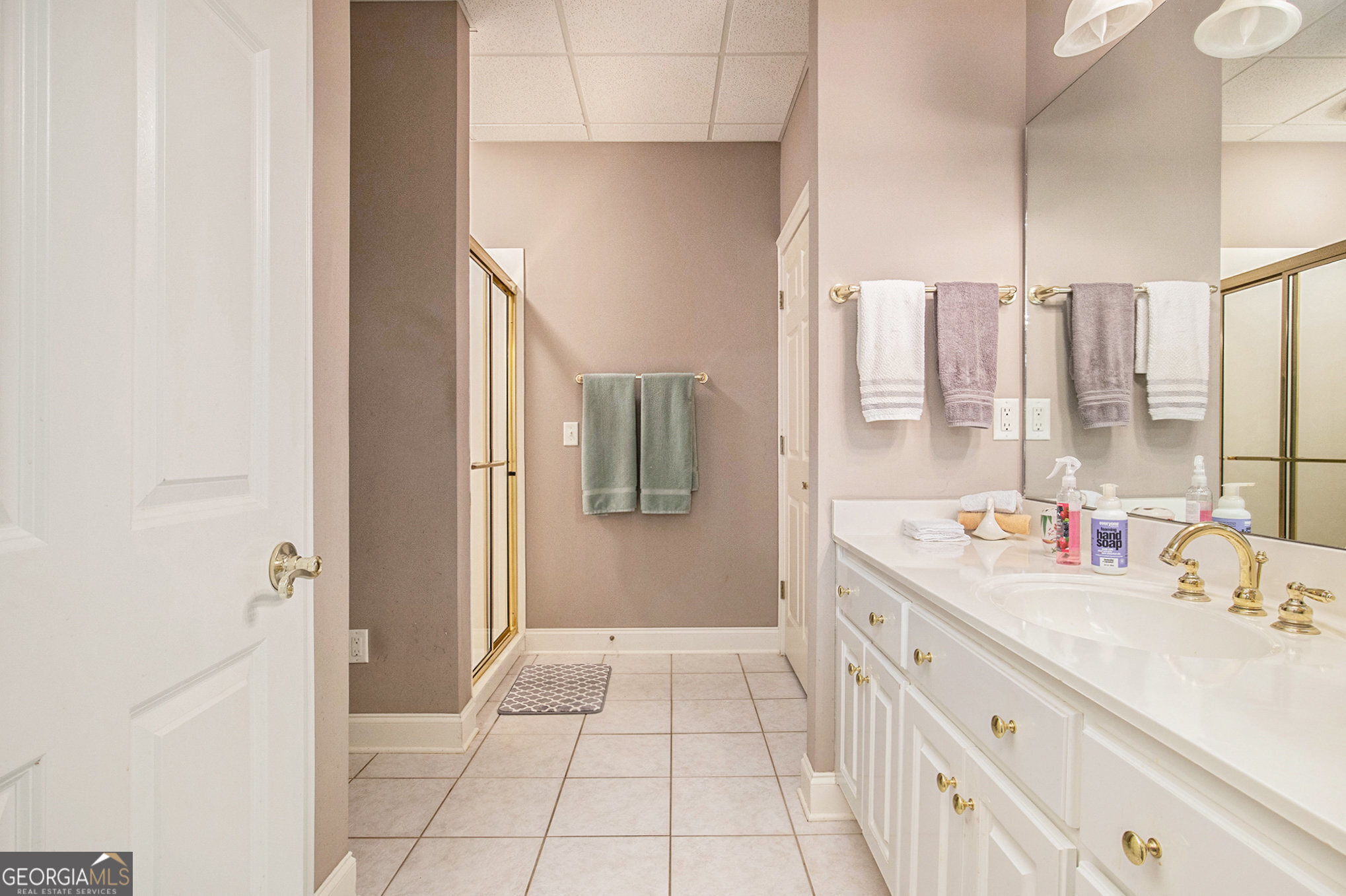 131 Winesap Way Clarkesville, GA 30523 - Photo 34 of 65 a bathroom with a double vanity sink a mirror and a shower
