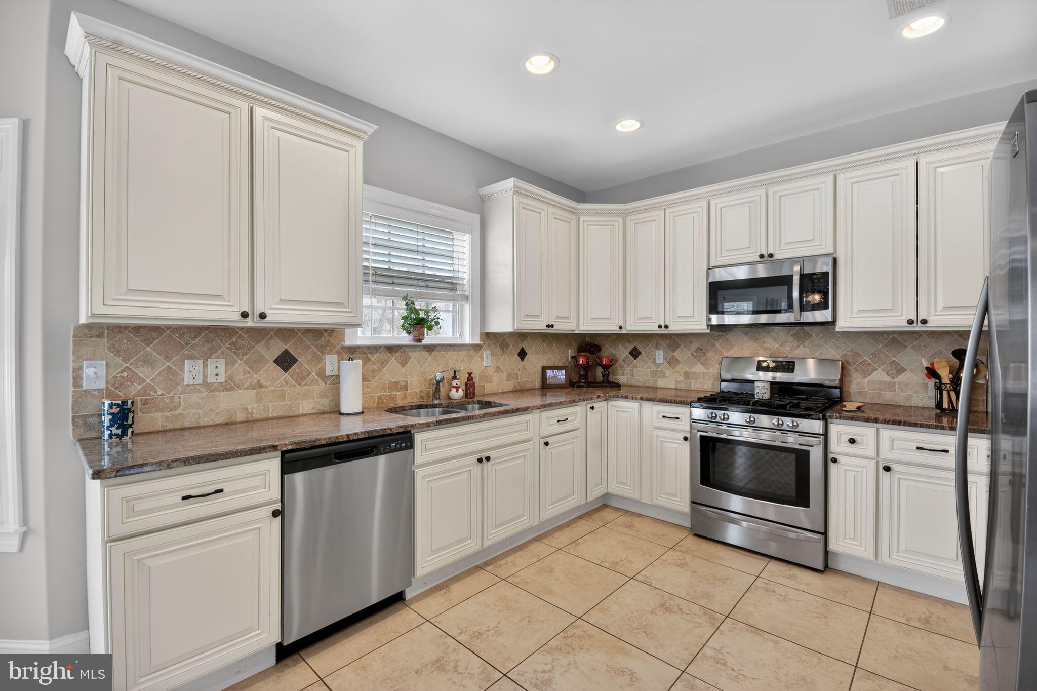 95 Savannah Road Manchester Township, NJ 08757 - Photo 11 of 37 a kitchen with white cabinets and appliances