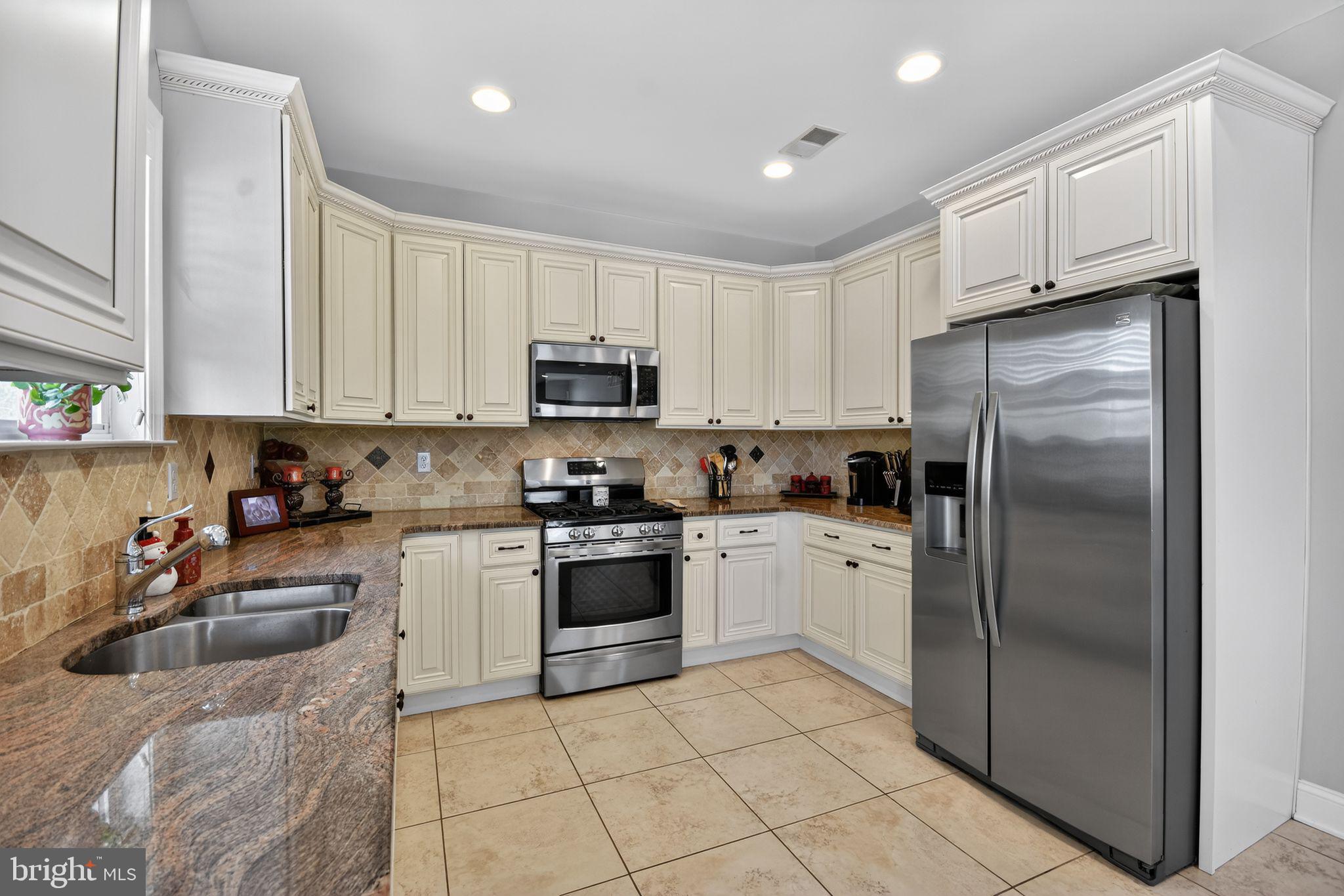 95 Savannah Road Manchester Township, NJ 08757 - Photo 12 of 37 a kitchen with cabinets stainless steel appliances and a counter top space