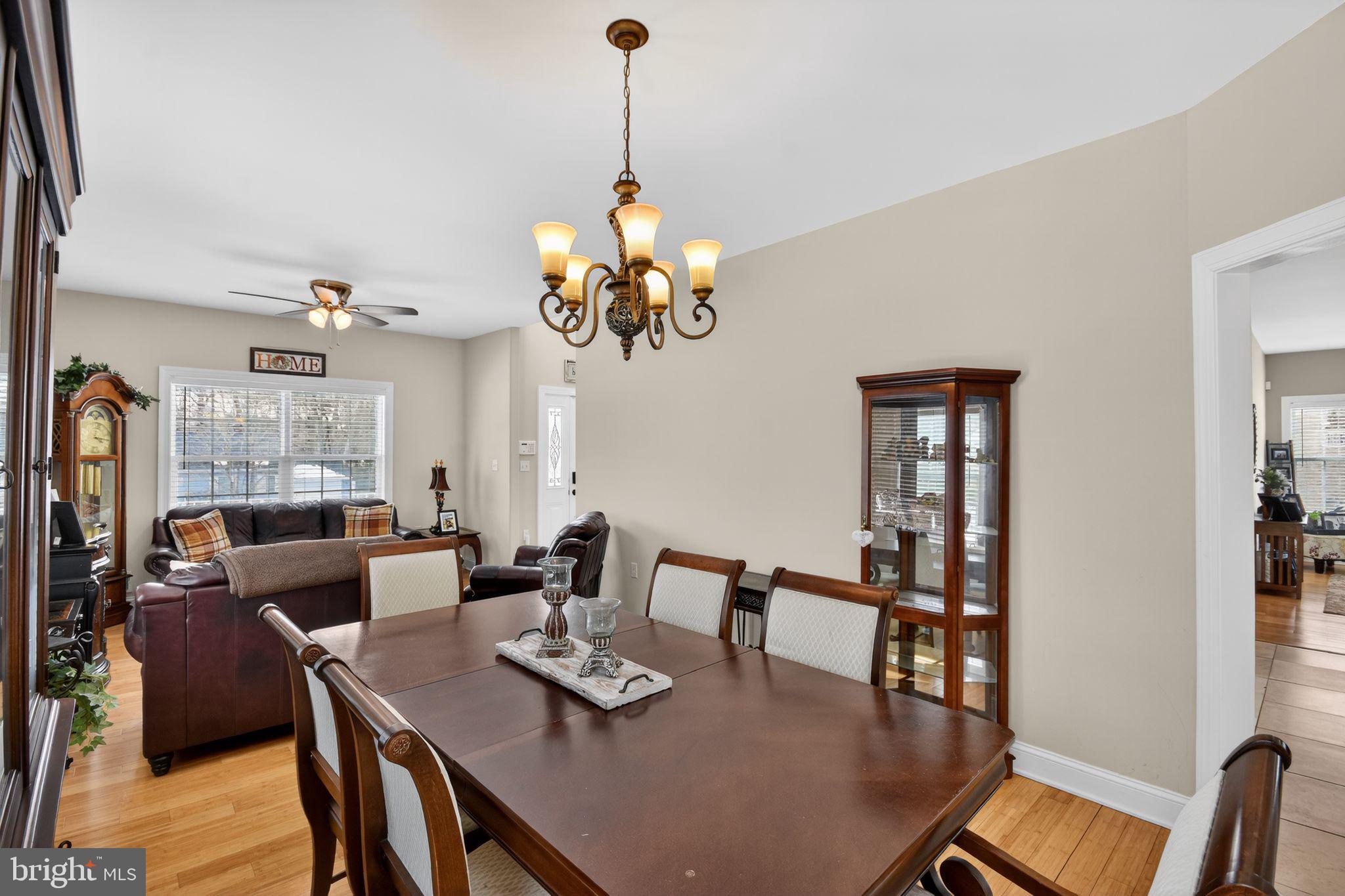 95 Savannah Road Manchester Township, NJ 08757 - Photo 15 of 37 a view of a dining room with furniture a chandelier and wooden floor