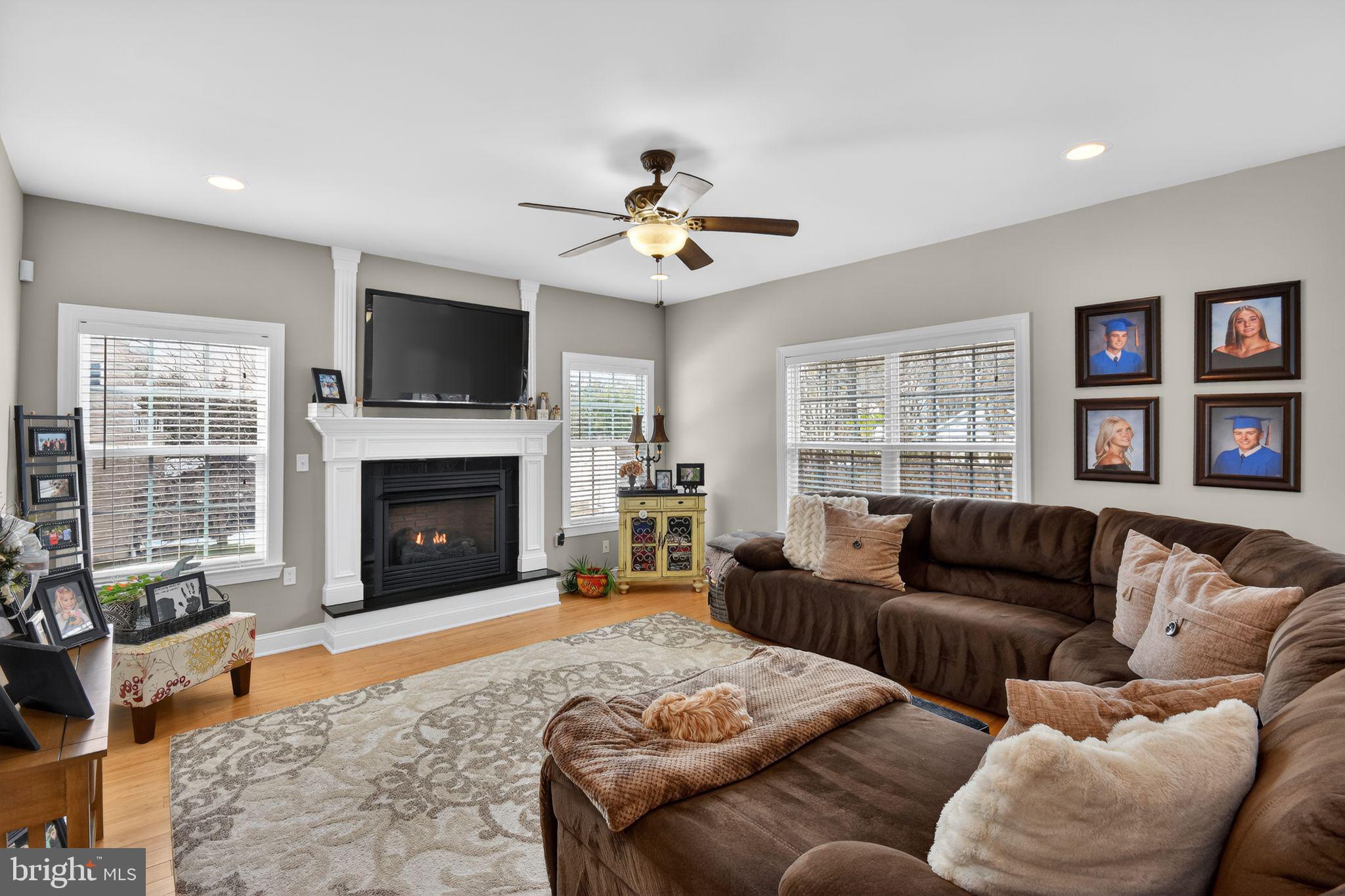 95 Savannah Road Manchester Township, NJ 08757 - Photo 4 of 37 a living room with furniture a flat screen tv and a fireplace