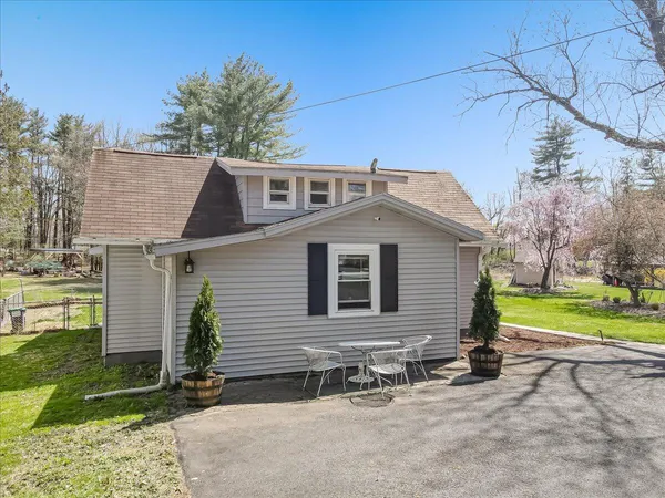 a house that has a tree in front of the house