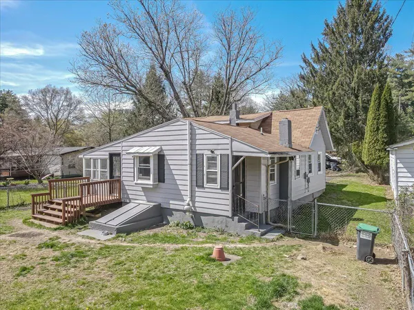 an aerial view of a house with yard garage and outdoor seating