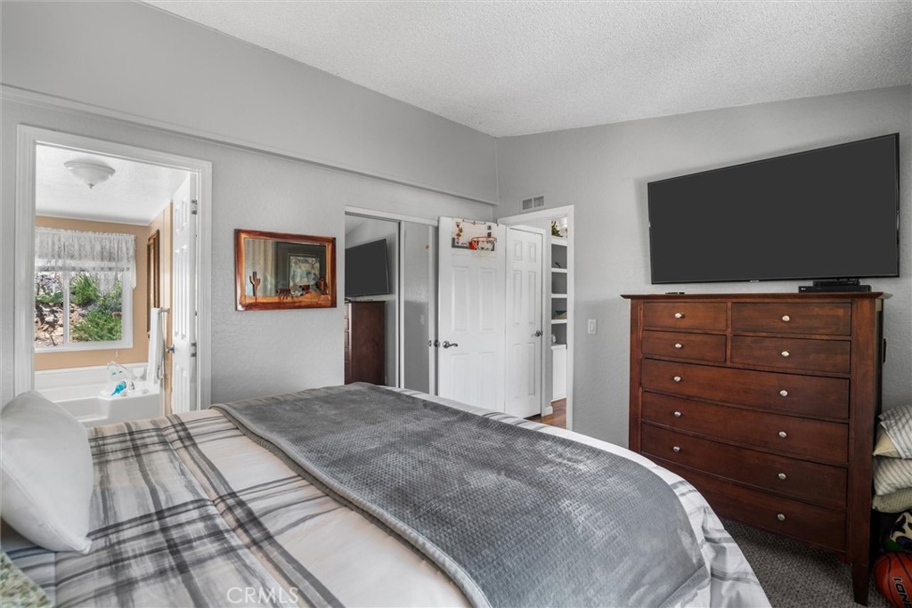 35109 Highway 79, Unit 116 Warner Springs, CA 92086 - Photo 42 of 72 a bedroom with a bed and a flat screen tv