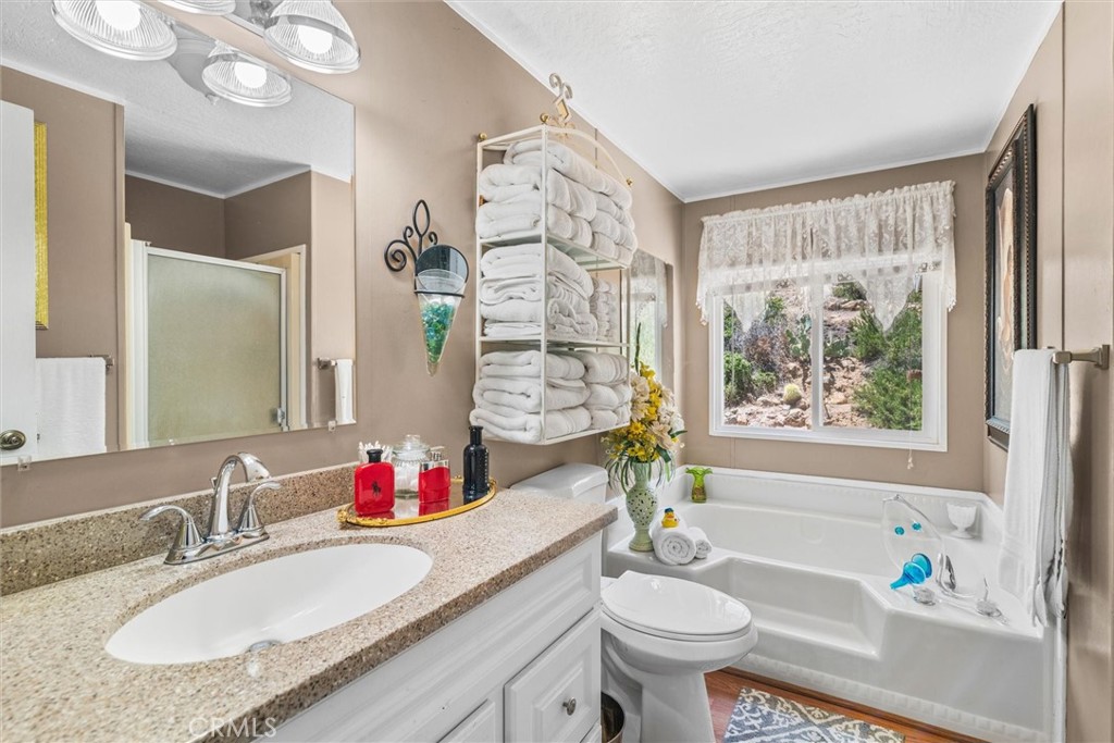 35109 Highway 79, Unit 116 Warner Springs, CA 92086 - Photo 44 of 72 a bathroom with a granite countertop sink and a mirror