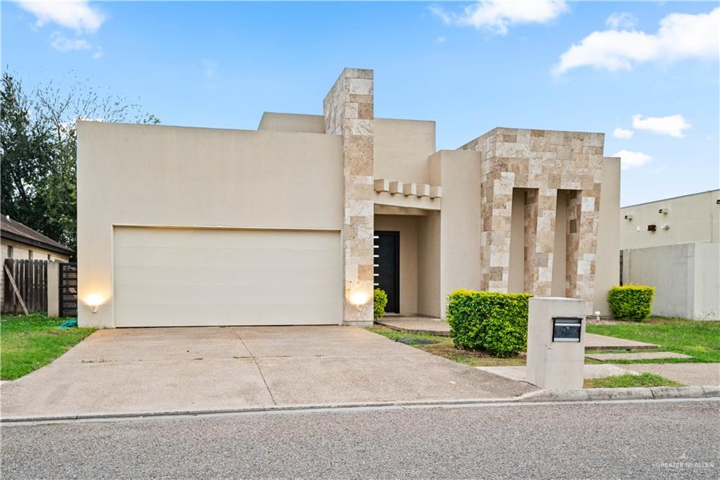 206 North Mockingbird Avenue Mission, TX 78572 - Photo 2 of 22 a view of a house with a yard and garage