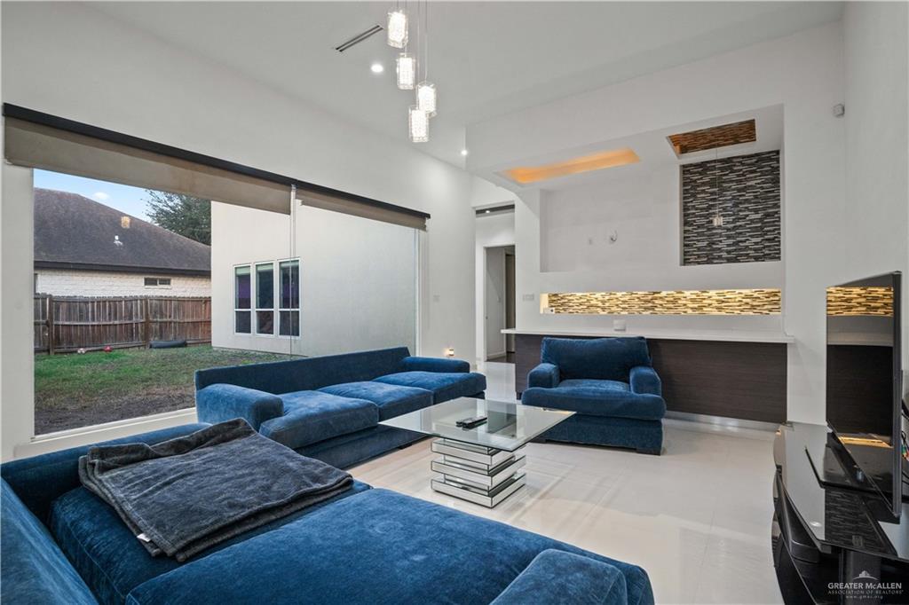 206 North Mockingbird Avenue Mission, TX 78572 - Photo 10 of 22 a living room with furniture and a flat screen tv