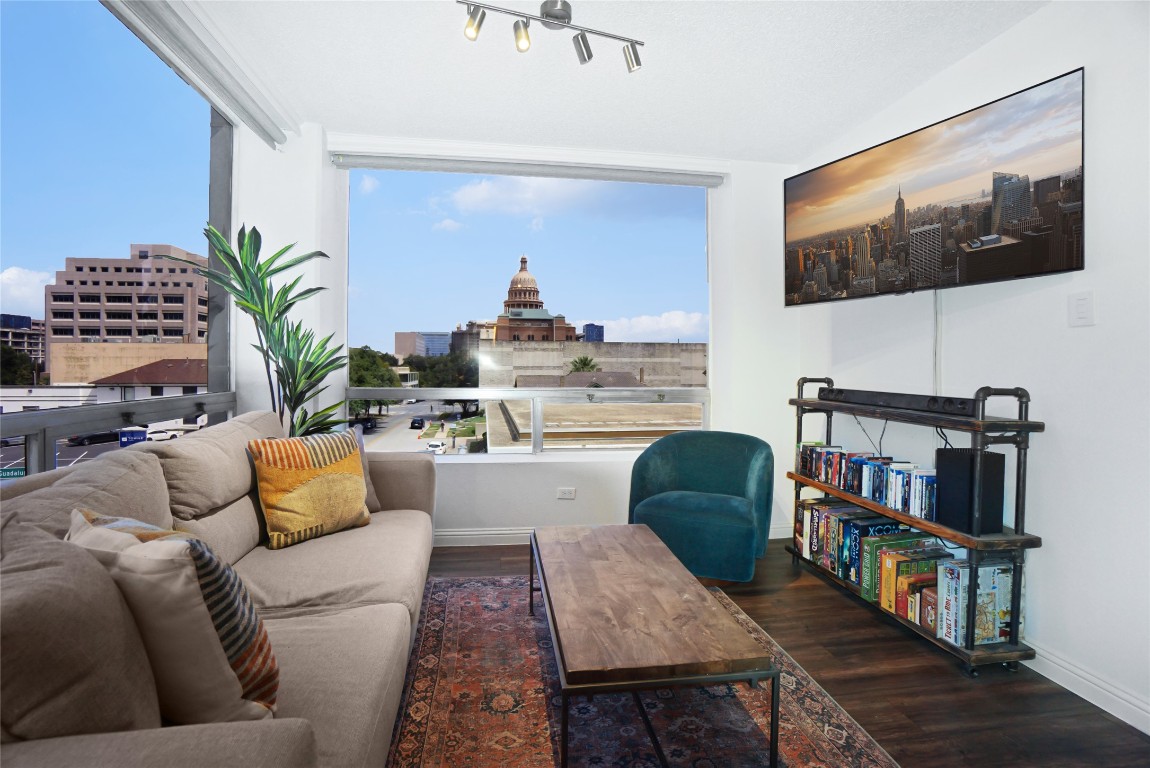1212 Guadalupe Street, Unit 402 Austin, TX 78701 - Photo 2 of 20 a living room with furniture and a flat screen tv