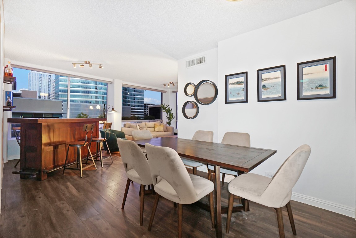 1212 Guadalupe Street, Unit 402 Austin, TX 78701 - Photo 3 of 20 a view of a dining room with furniture and wooden floor