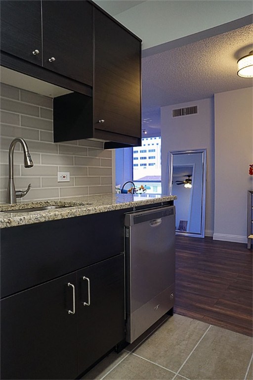 1212 Guadalupe Street, Unit 402 Austin, TX 78701 - Photo 9 of 20 a kitchen with granite countertop stainless steel appliances a sink and cabinets