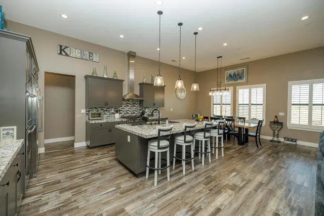 a large kitchen with a table and chairs