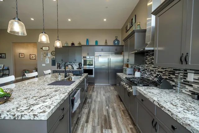 a kitchen with cabinets and stainless steel appliances