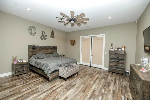 a bathroom with a granite countertop sink a mirror and bathtub