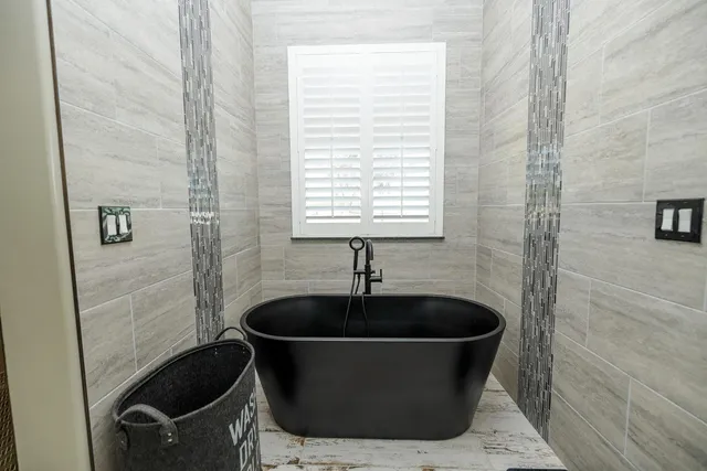 a spacious bathroom with a granite countertop sink and a mirror