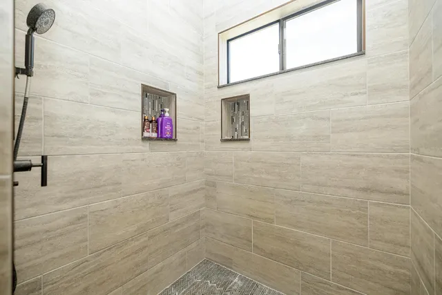 a spacious bathroom with a double vanity sink and a mirror
