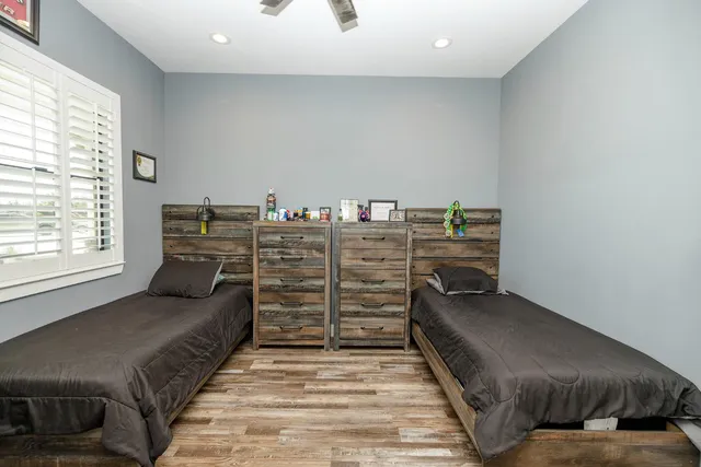 a bathroom with a granite countertop sink a toilet and shower
