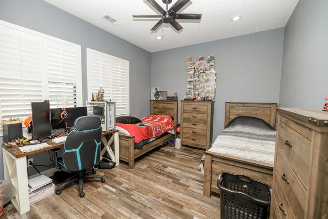 a bathroom with a granite countertop sink toilet and a mirror