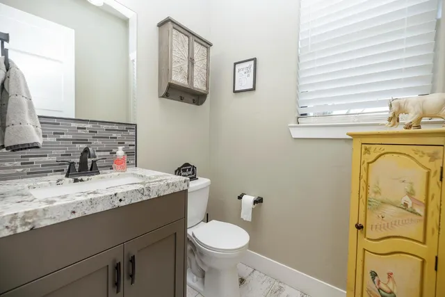 an aerial view of a house with yard and swimming pool