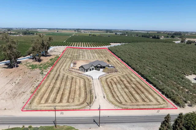 a view of a patio with lawn chairs floor to ceiling window and an outdoor space