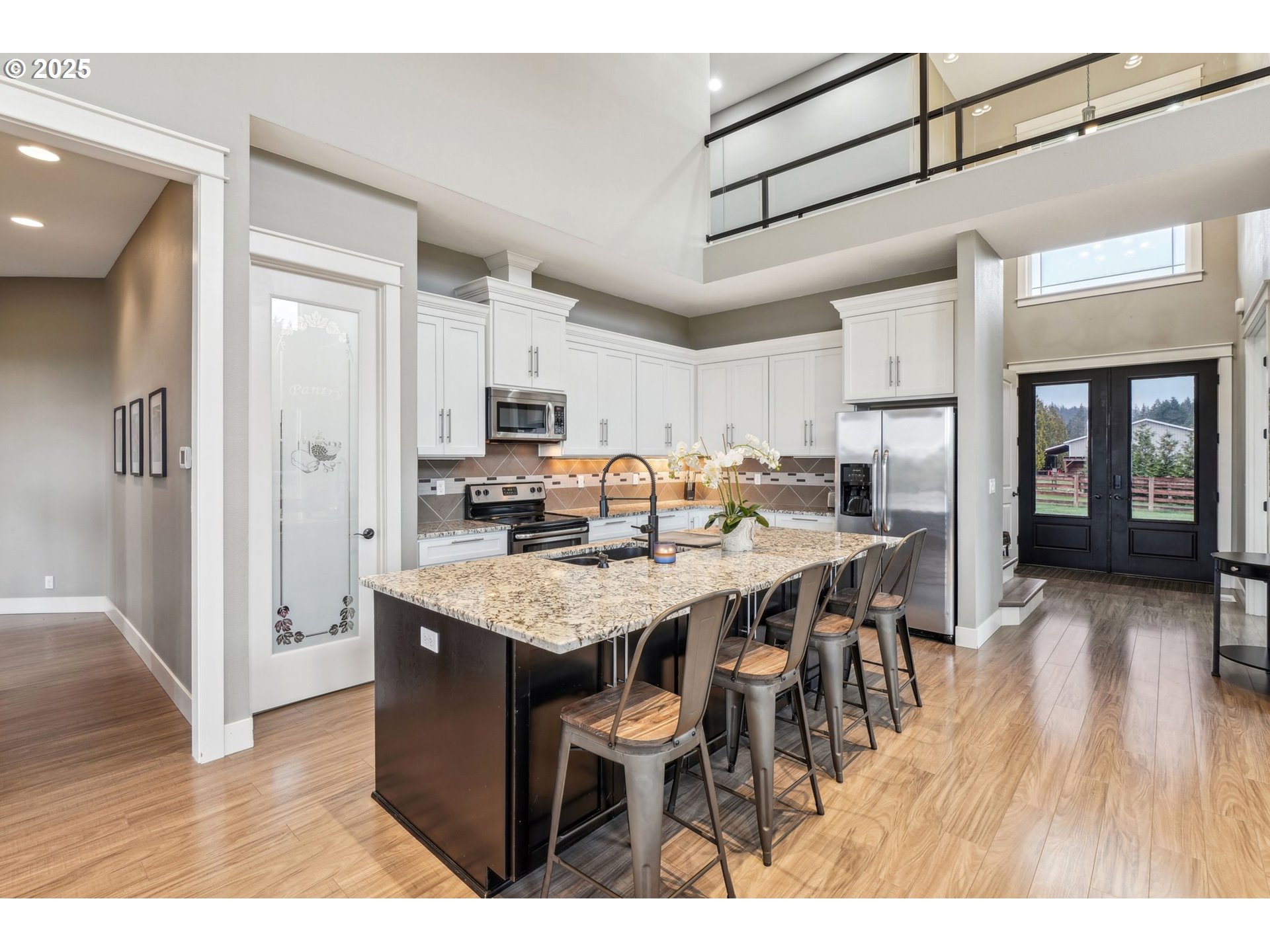 18147 Southeast Troge Road Damascus, OR 97089 - Photo 12 of 45 a open kitchen with stainless steel appliances granite countertop a table chairs refrigerator and sink