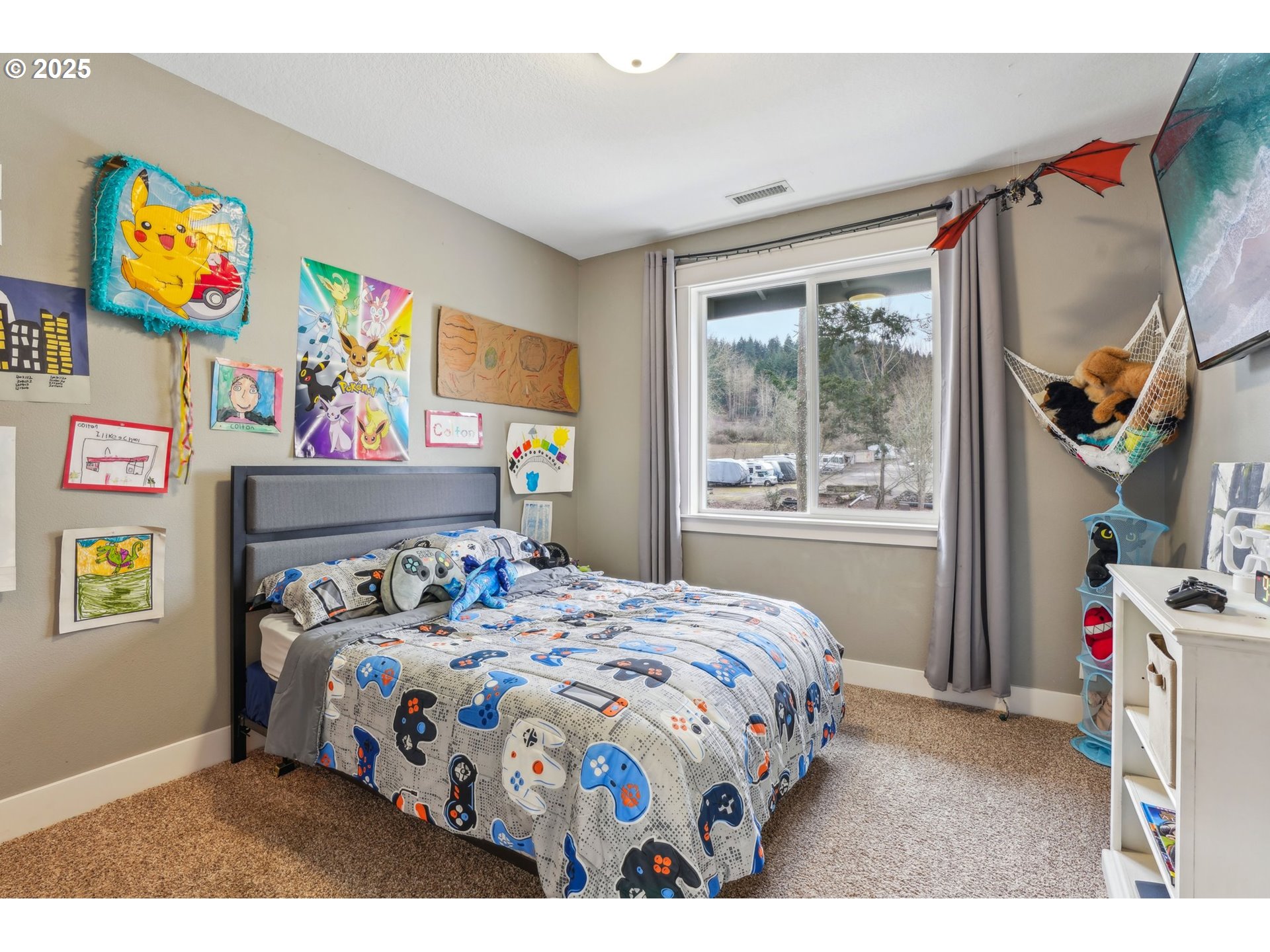18147 Southeast Troge Road Damascus, OR 97089 - Photo 29 of 45 a bedroom with a bed a dresser next to a window