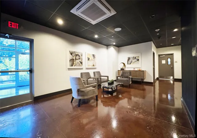 a living room with furniture and a floor to ceiling window