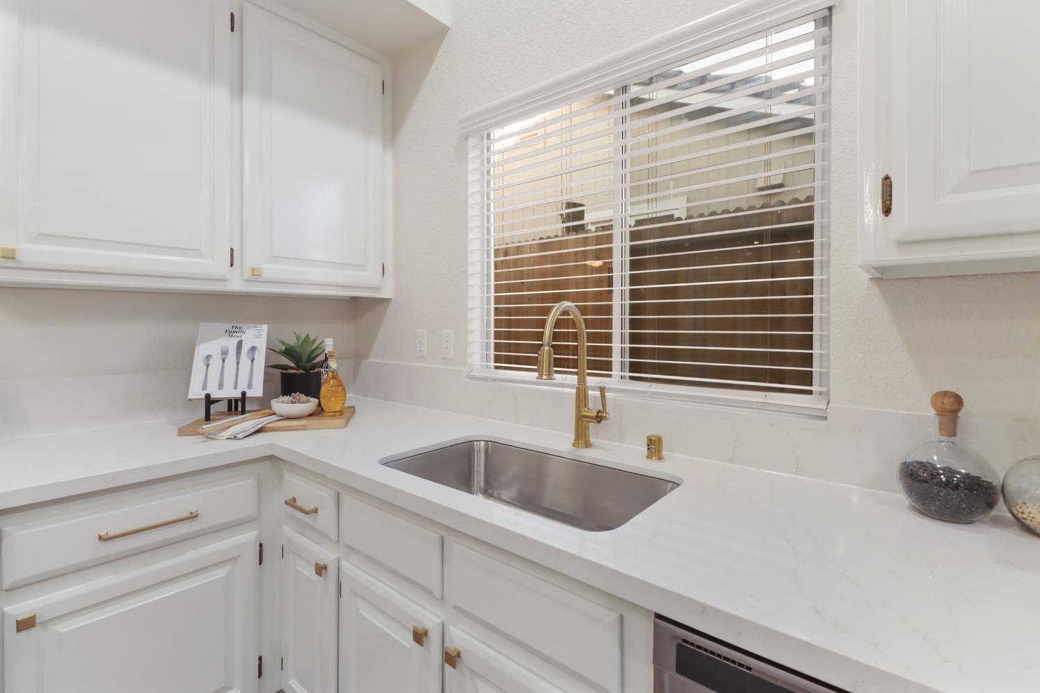 4711 Stuart Street Rocklin, CA 95765 - Photo 15 of 48 a kitchen with granite countertop a sink and a white wooden cabinets