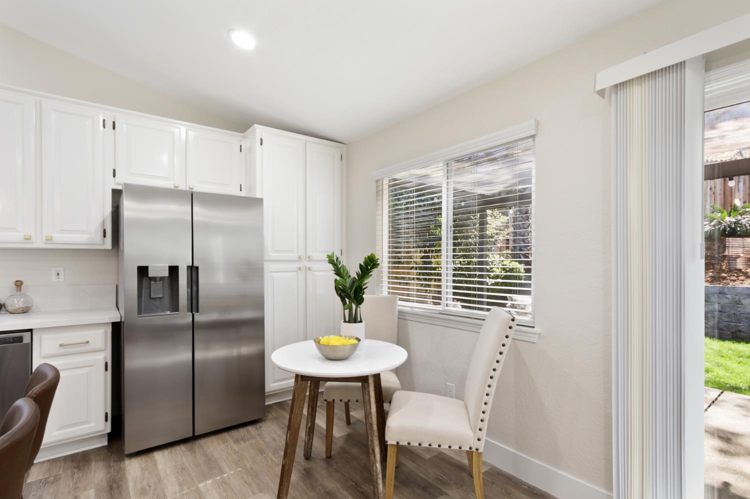 4711 Stuart Street Rocklin, CA 95765 - Photo 20 of 48 a kitchen with stainless steel appliances a dining table chairs and chandelier