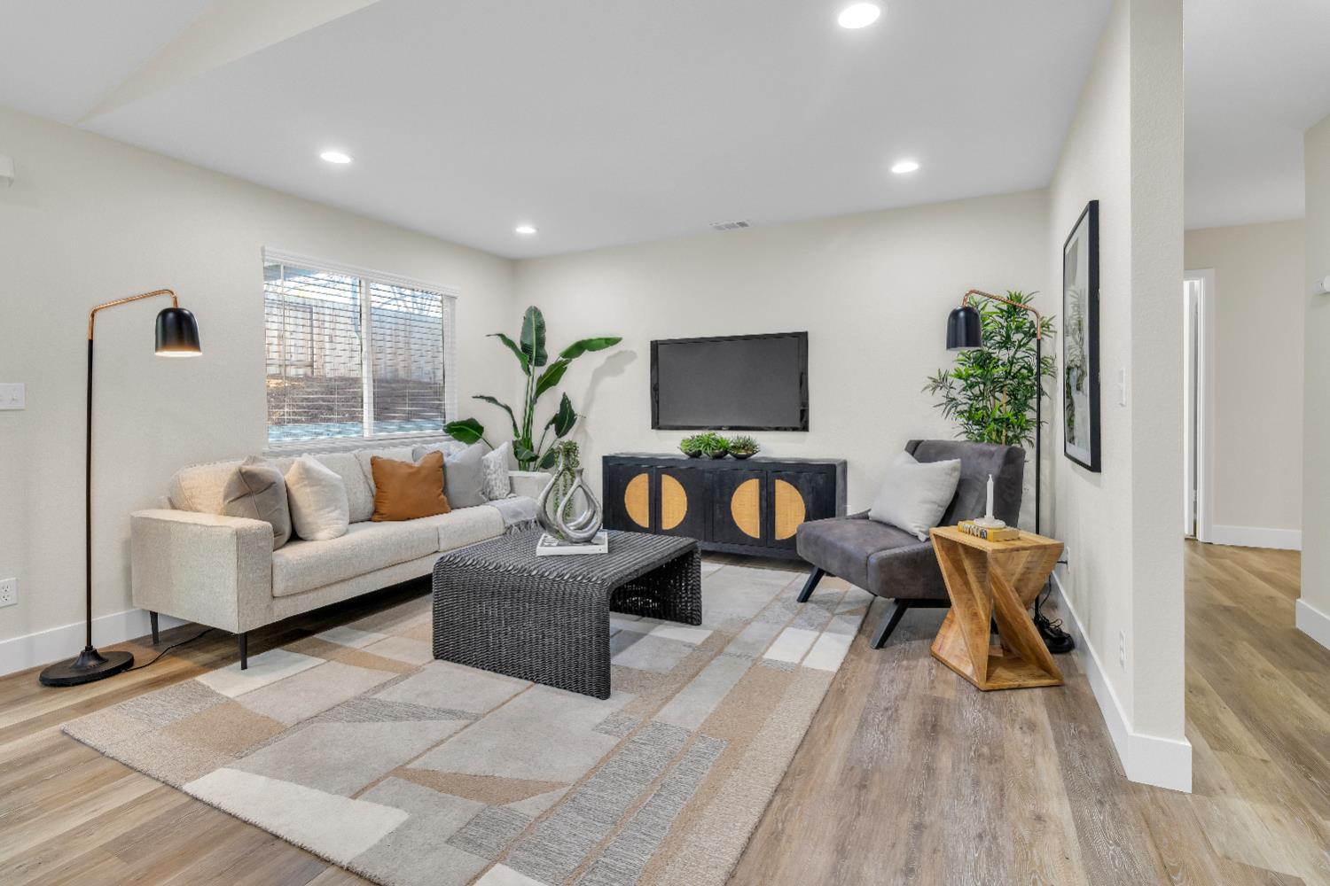 4711 Stuart Street Rocklin, CA 95765 - Photo 26 of 48 a living room with furniture a flat screen tv and a large window