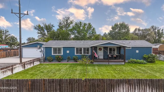 a view of a house with a yard and a garden