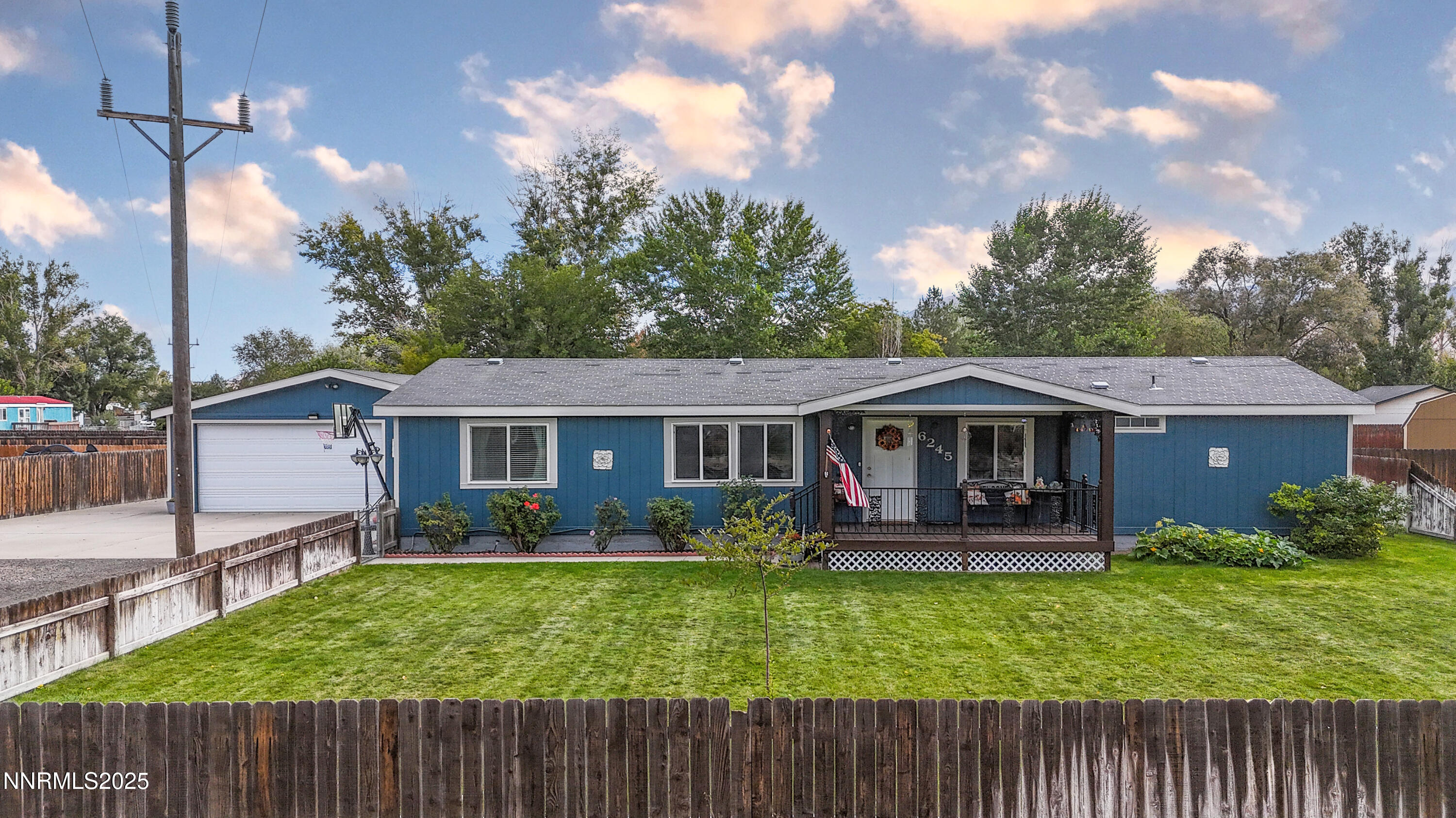 a view of a house with a yard and a garden