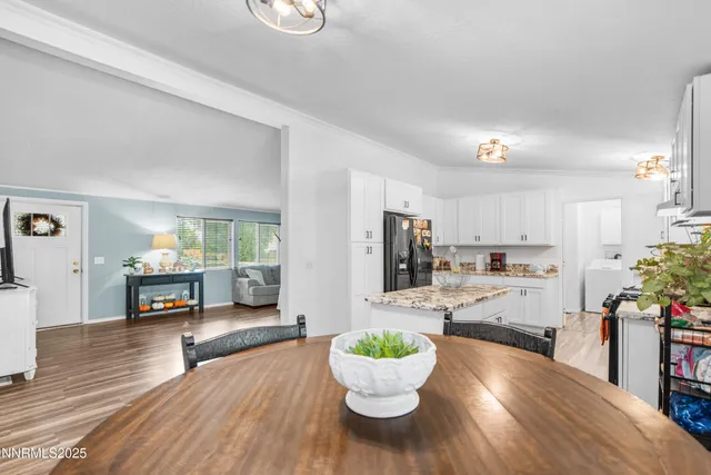 a living room with kitchen island furniture and a wooden floor