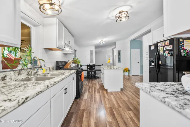 a kitchen with kitchen island granite countertop lots of counter top space and stainless steel appliances
