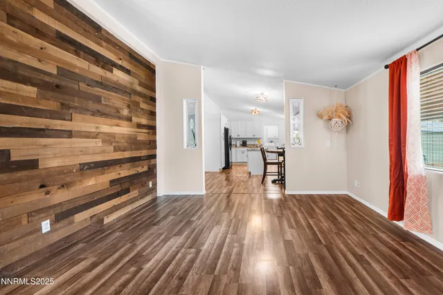 a view of hallway with wooden floor and a window