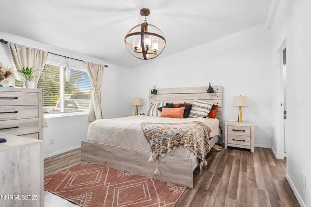 a bedroom with a large bed and a window