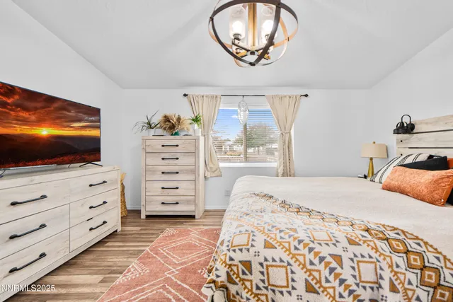 a bedroom with a bed and flat screen tv