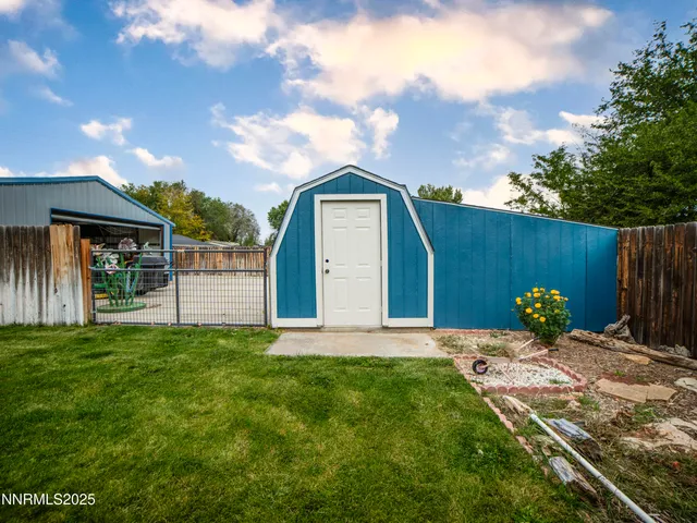 a backyard of a house with table and chairs