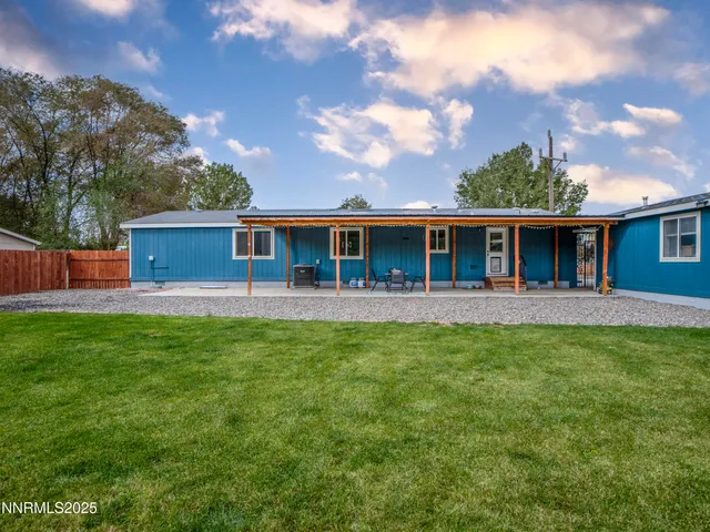 a view of a house with a backyard