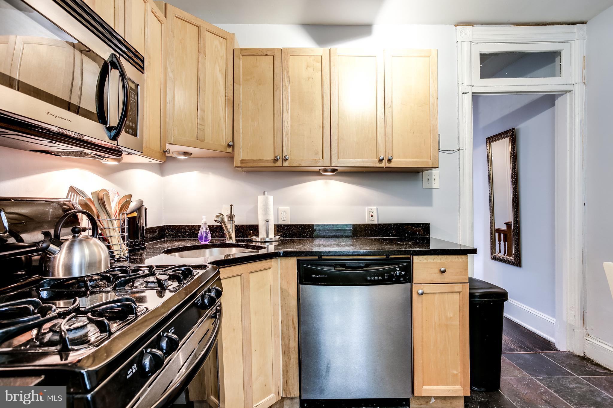 1211 33rd Street Northwest, Unit 2 Washington, DC 20007 - Photo 16 of 23 a kitchen with stainless steel appliances a stove a sink and a refrigerator