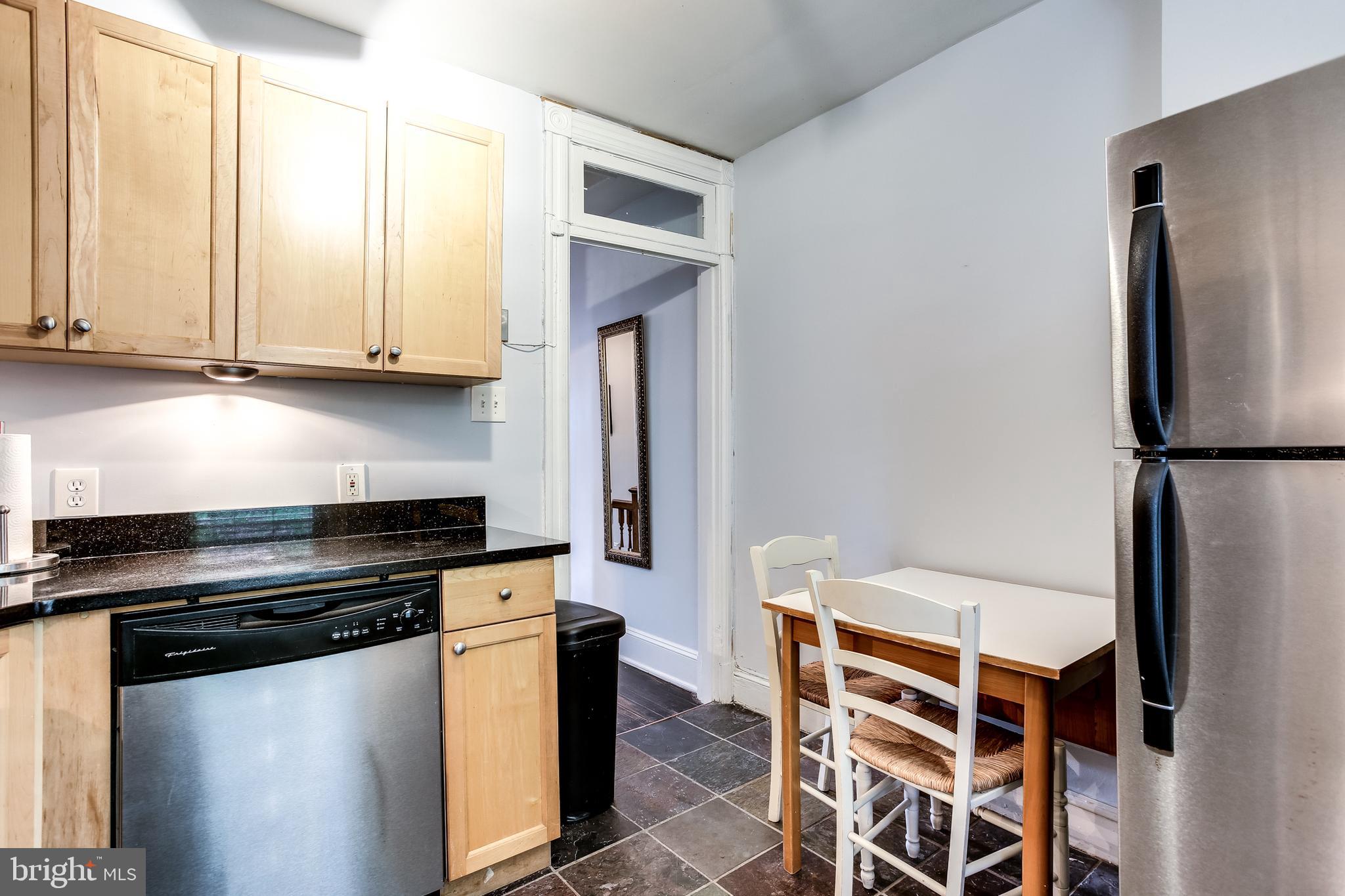 1211 33rd Street Northwest, Unit 2 Washington, DC 20007 - Photo 17 of 23 a kitchen with granite countertop a refrigerator and a stove top oven