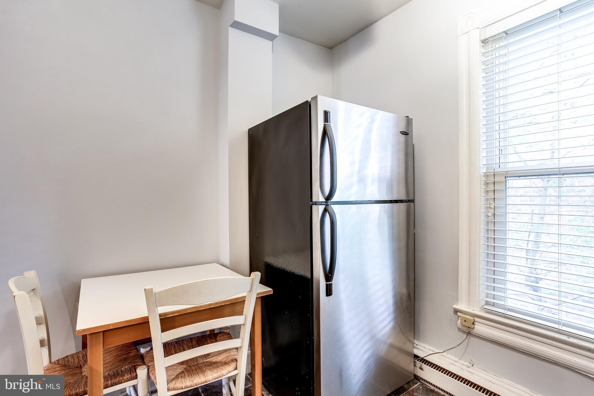 1211 33rd Street Northwest, Unit 2 Washington, DC 20007 - Photo 18 of 23 a kitchen with a refrigerator and window