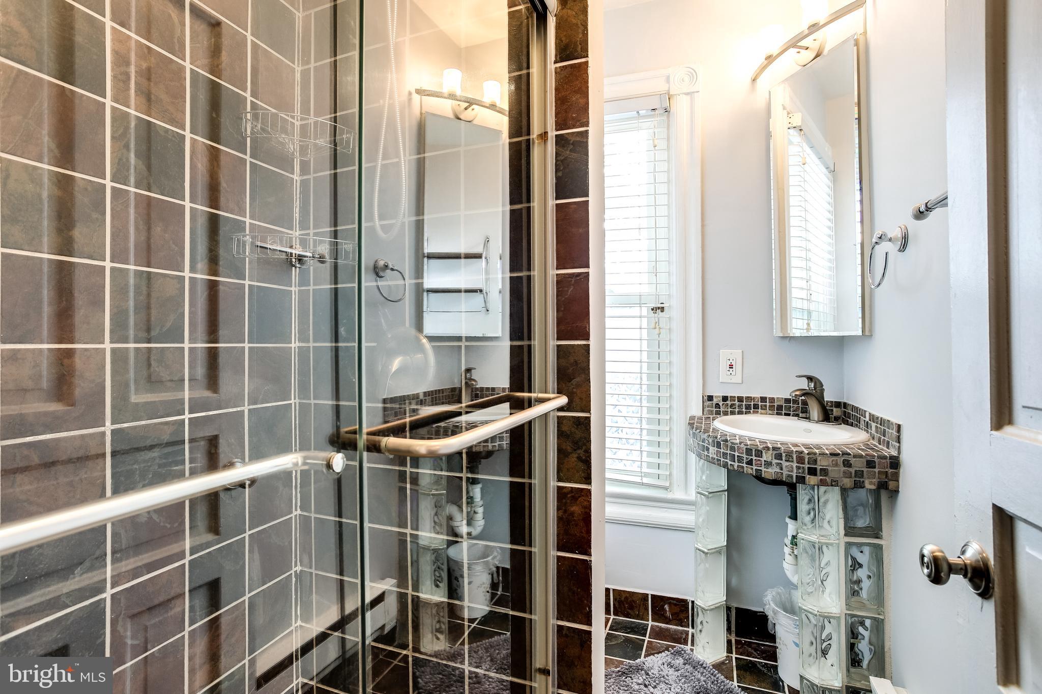 1211 33rd Street Northwest, Unit 2 Washington, DC 20007 - Photo 19 of 23 a bathroom with a sink and a shower