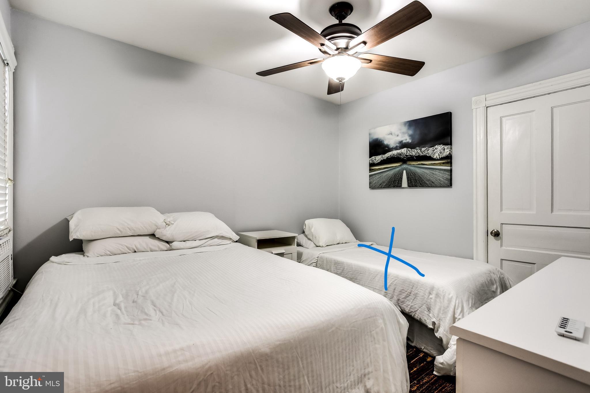 1211 33rd Street Northwest, Unit 2 Washington, DC 20007 - Photo 21 of 23 a bedroom with a bed and a chandelier
