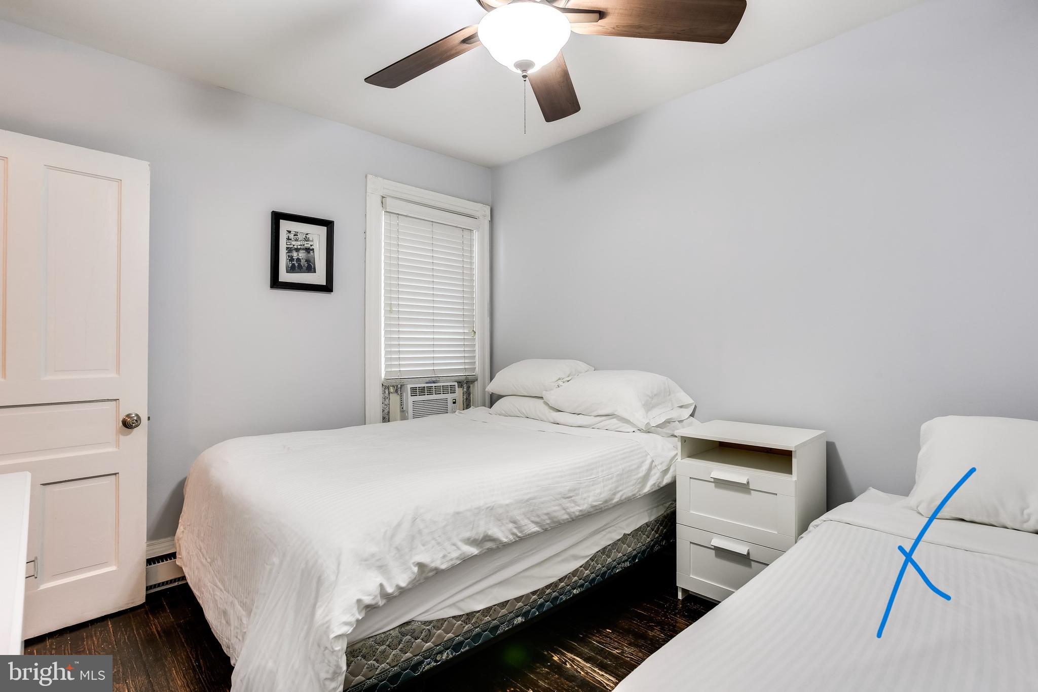 1211 33rd Street Northwest, Unit 2 Washington, DC 20007 - Photo 22 of 23 a bedroom with a bed and a chandelier