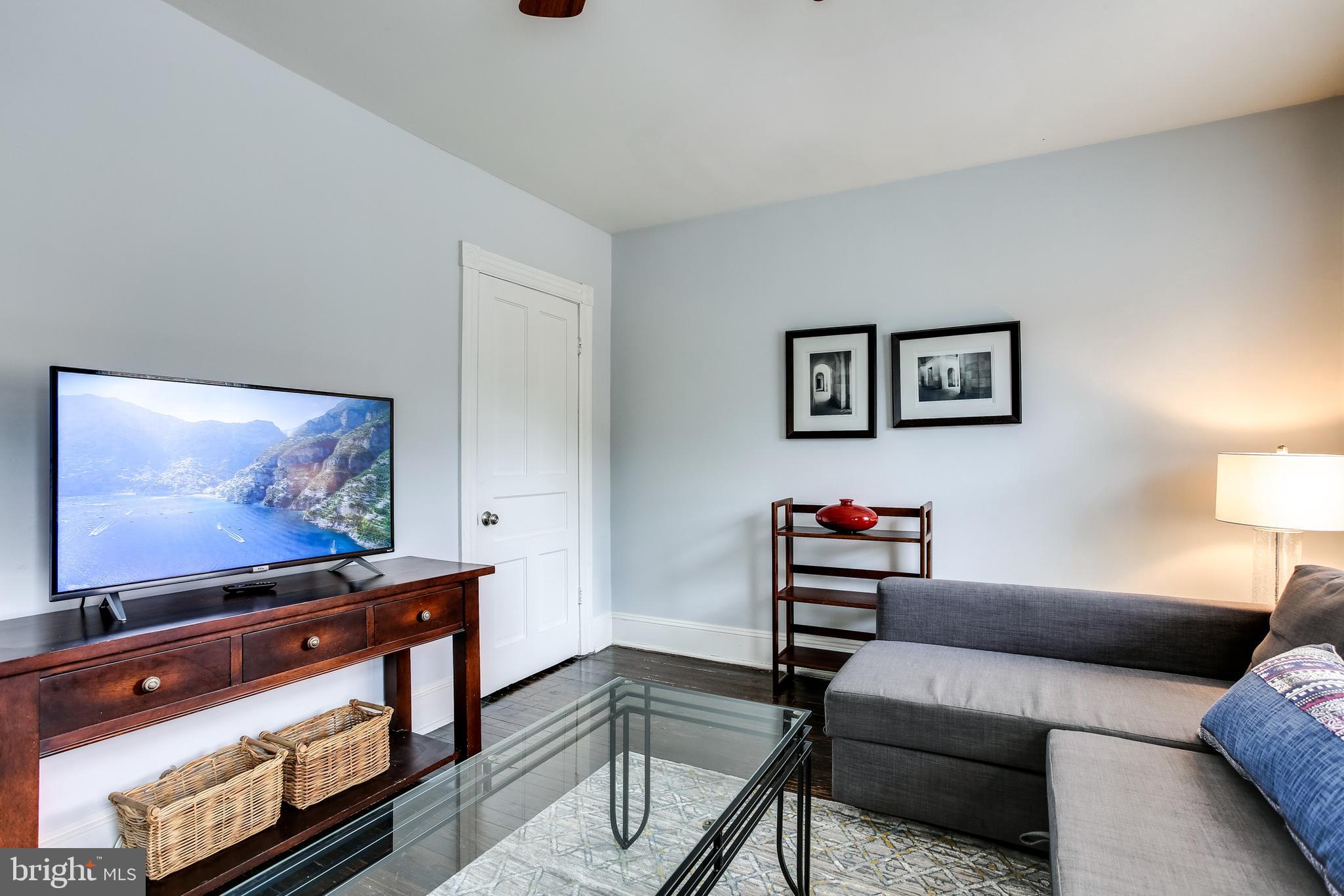 1211 33rd Street Northwest, Unit 2 Washington, DC 20007 - Photo 5 of 23 a living room with furniture and a flat screen tv