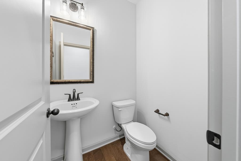 331 Lee Road 0357 Valley, AL 36854 - Photo 12 of 30 a bathroom with a toilet sink and mirror