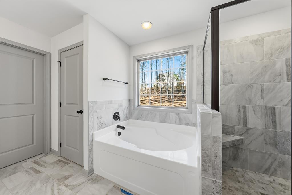 331 Lee Road 0357 Valley, AL 36854 - Photo 20 of 30 a white bath tub sitting in a spacious bathroom next to a window