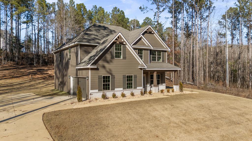 331 Lee Road 0357 Valley, AL 36854 - Photo 2 of 30 a front view of a house with large trees and plants