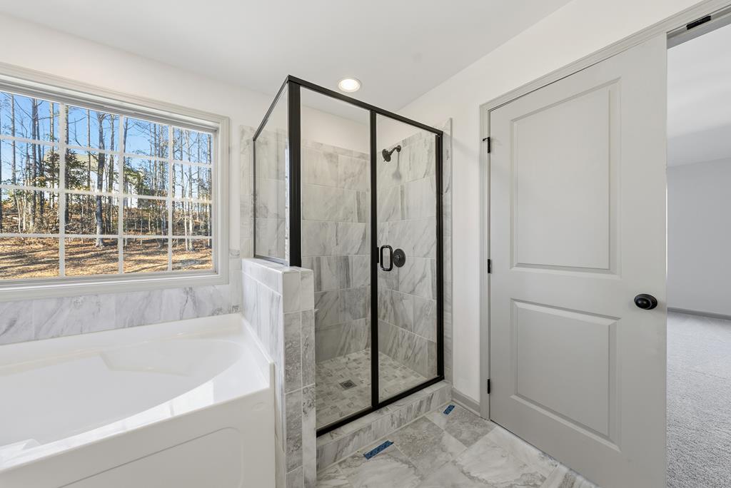 331 Lee Road 0357 Valley, AL 36854 - Photo 21 of 30 a bathroom with a bathtub and a shower